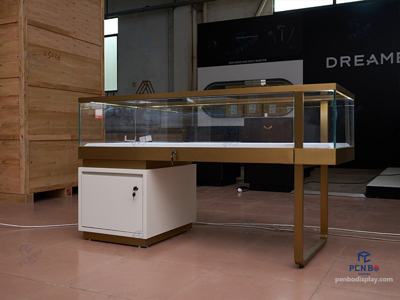 custom glass jewelry display counter with gold frame and storage cabinet