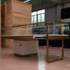 custom glass jewelry display counter with gold frame and storage cabinet
