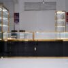 glass jewelry showcase for retail stores with gold frame and black bas