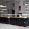 glass jewelry showcase for retail stores with gold frame and black bas