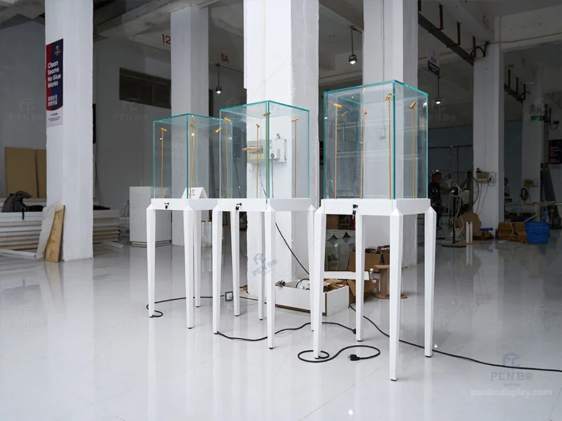 Tall white pedestal glass display cases for jewelry with built-in LED lights and locks