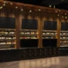 Custom bottle display cabinet with illuminated shelving for modern bar