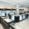 Full store custom luxury jewelry display showcase setup in black and gold with backlit logo wall cabinets by Penbo Display