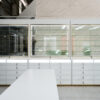 White and gold optical store glass display cabinet with built-in LED shelving and lockable storage drawers