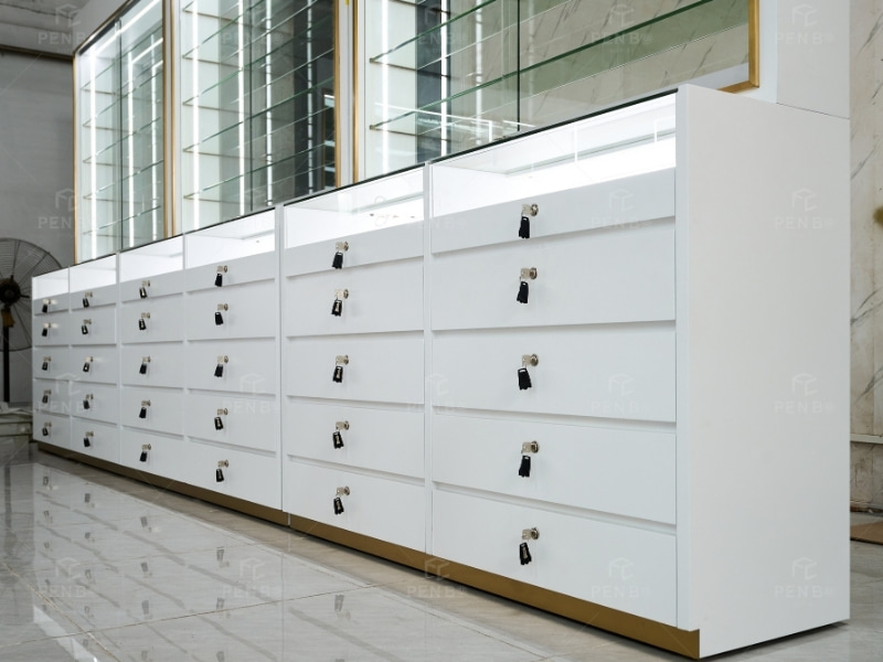 White and gold optical store glass display cabinet with built-in LED shelving and lockable storage drawers