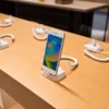 Wooden mobile phone display table with security holders for a cell phone store