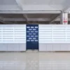 Custom optical store furniture arranged in a factory with illuminated wall shelves and white storage cabinets
